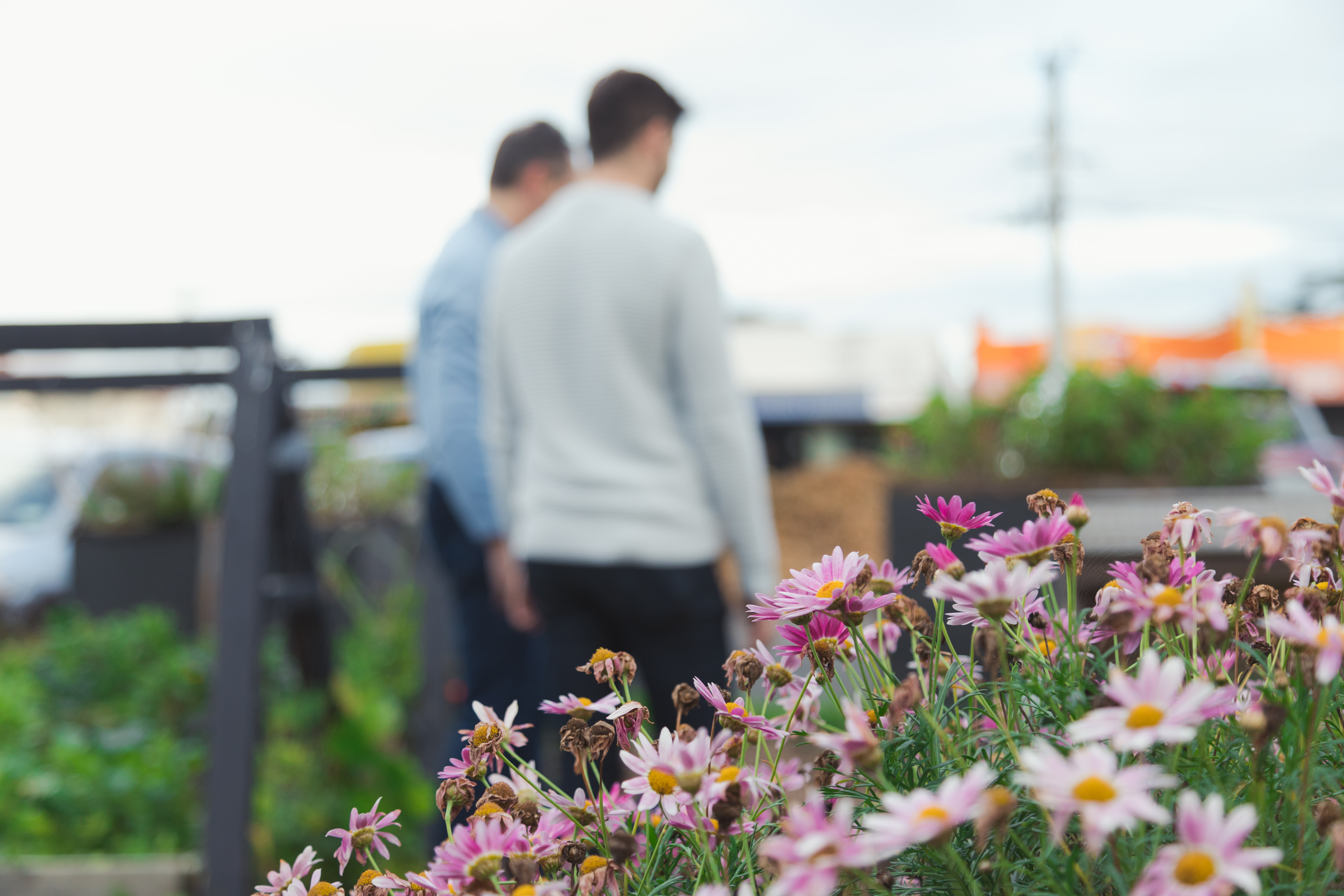 2 people walking in a garden