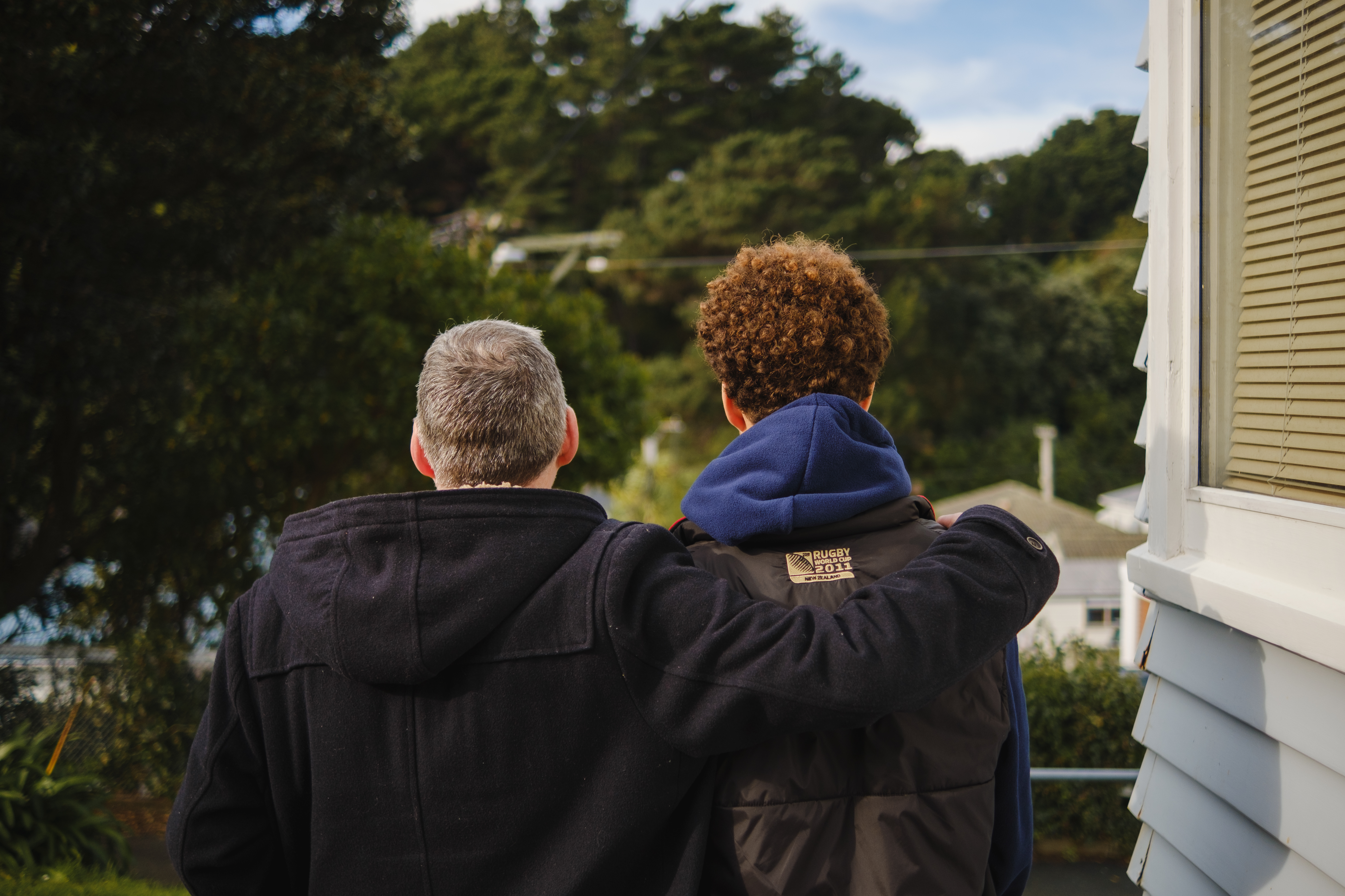 Father and son with backs to the camera