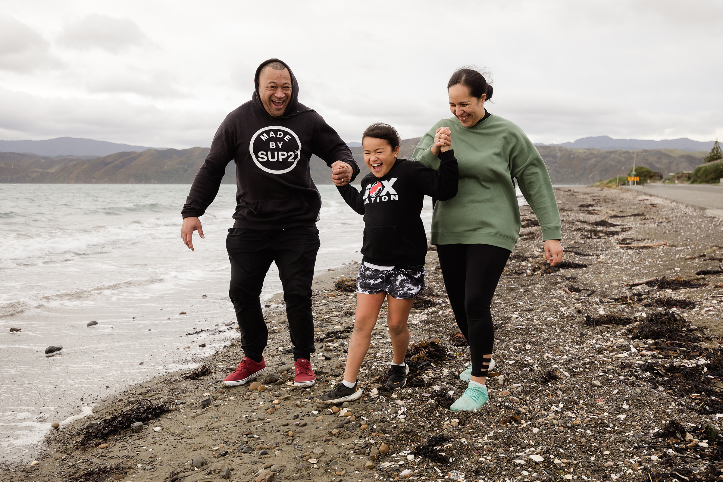 Whanau walking on beach