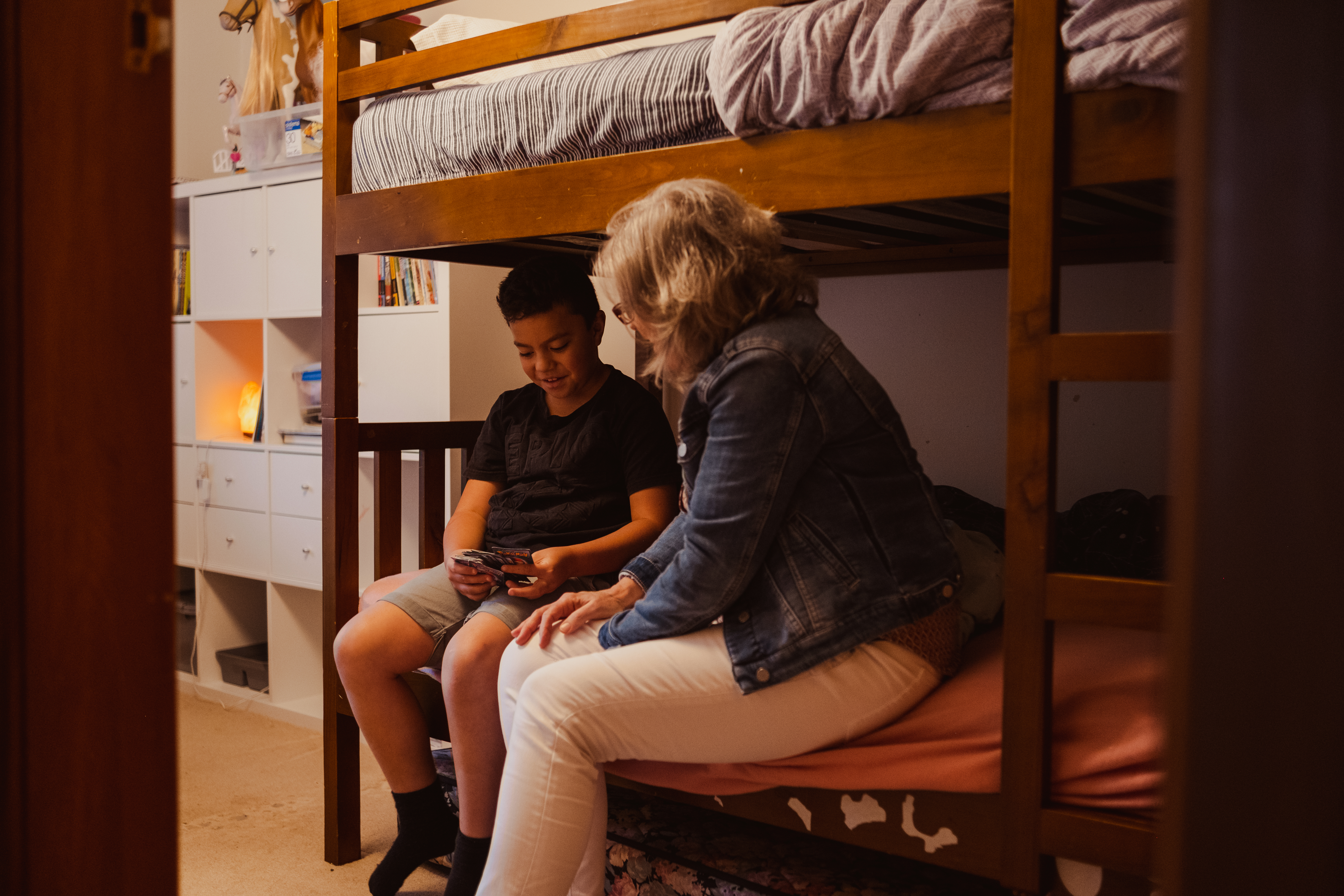 Social worker and boy on bunk bed