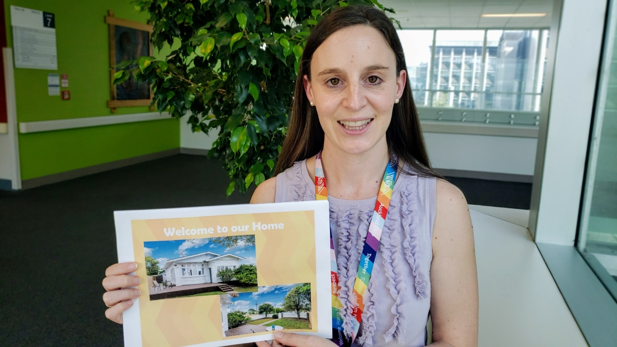 Head and shoulders of Kristin holding her Welcome to Our Home booklet