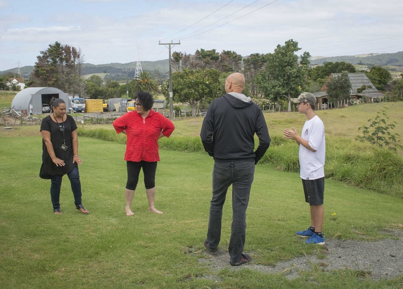 Tame, Sharon, Cameron and Rachel talk outside about the history of the surrounding area with the Brynderwyn Hills in the background
