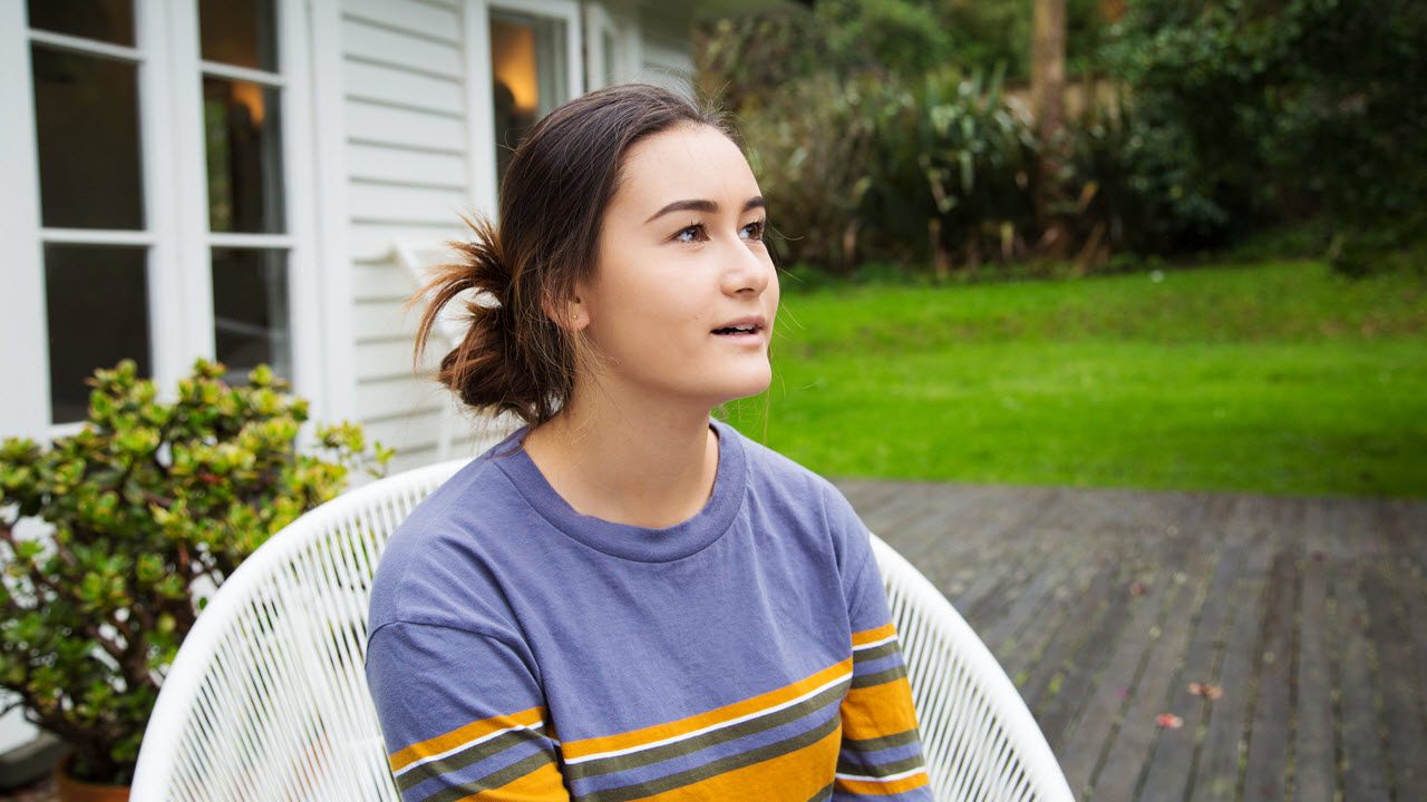 Teenage girl sitting outside
