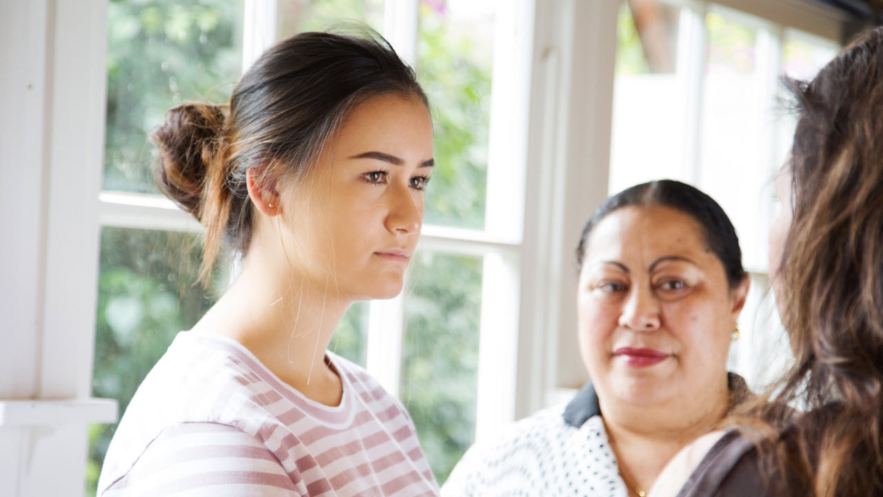 Teenage girl with two women